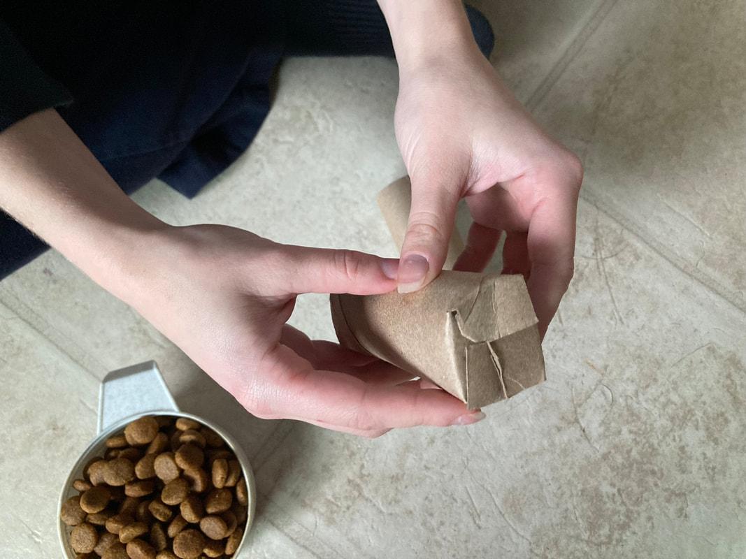 Dog treats hidden in cardboard puzzle